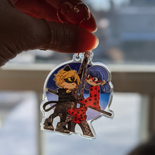 Load image into Gallery viewer, Chat Noir and Ladybug Acrylic Charm

